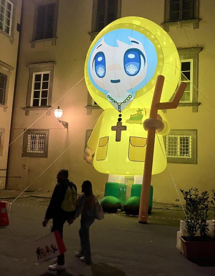 The meme features a large, cartoonish depiction of the Italian Catholic saint, Saint Anthony of Padua, but instead of his traditional image, he's a giant, smiling, anime-style character. The image has the text "SAINT ANTHONY OF PADUA" written above it, but the text is in a playful, cursive font. The overall tone of the meme is lighthearted and humorous, poking fun at the idea of a saint being so... cheerful.